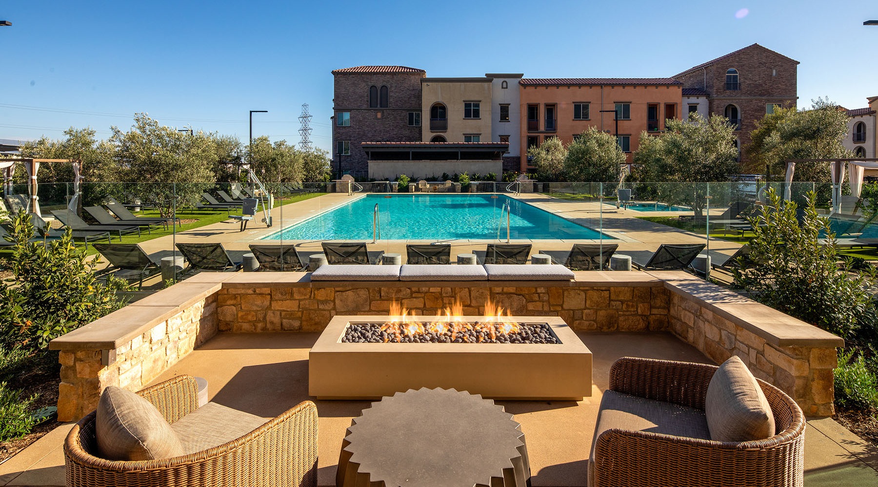 view of firepit seating looking out to resort style pool