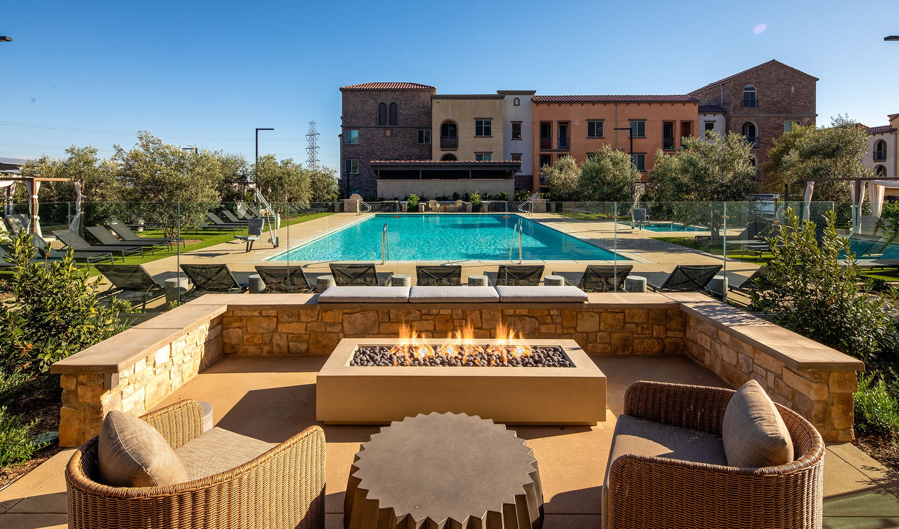 view of firepit seating looking out to resort style pool
