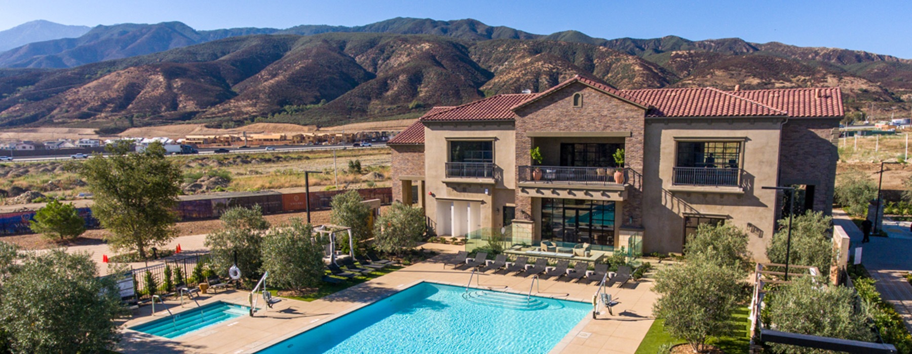 aerial view of pool building and mountain range