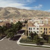 an apartment community with trees with a mountain  range in the background